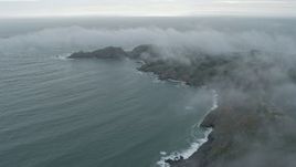 6K aerial stock footage of flying by wisps of fog over coastal cliffs, Marin Headlands, California Aerial Stock Footage | AX0173_0099