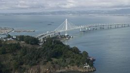 6K aerial stock footage of the Bay Bridge by Yerba Buena Island, California Aerial Stock Footage | AX0173_0130