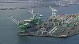 6K aerial stock footage of passing cargo cranes and ship at the Port of Oakland, California Aerial Stock Footage | AX0173_0131
