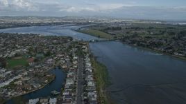 6K aerial stock footage fly over waterfront homes in Alameda toward Oakland Airport, California Aerial Stock Footage | AX0173_0135