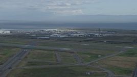 6K aerial stock footage a wide view of runways and hangars at Oakland Airport, California Aerial Stock Footage | AX0173_0136