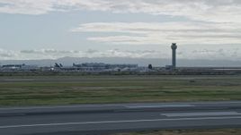 6K aerial stock footage of control tower and runways at Oakland Airport, California Aerial Stock Footage | AX0173_0139