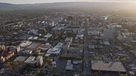 6K aerial stock footage of tilting from urban homes to reveal Downtown San Jose at sunset, California Aerial Stock Footage | AX0174_0029