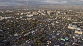 6K aerial stock footage of tilting from urban homes to reveal Downtown San Jose at sunset, California Aerial Stock Footage | AX0174_0034