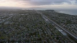 6K aerial stock footage of flying over San Mateo suburban neighborhoods at sunset, California Aerial Stock Footage | AX0174_0061