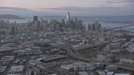 6K aerial stock footage tilt from South of Market neighborhood to reveal San Francisco skyline at sunset, California Aerial Stock Footage | AX0174_0078