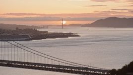 6K aerial stock footage of the Golden Gate Bridge and setting sun, seen from the Bay Bridge, California Aerial Stock Footage | AX0174_0089