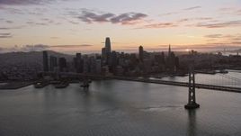 6K aerial stock footage of approaching the Bay Bridge and the Downtown San Francisco skyline at sunset, California Aerial Stock Footage | AX0174_0091