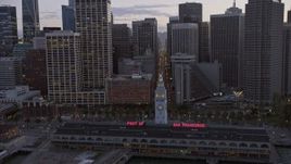 6K aerial stock footage tilt from the bay to reveal and fly over Downtown San Francisco skyscrapers at twilight, California Aerial Stock Footage | AX0174_0100