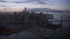 6K aerial stock footage of a reverse view of Downtown San Francisco skyscrapers at twilight, California Aerial Stock Footage | AX0174_0110