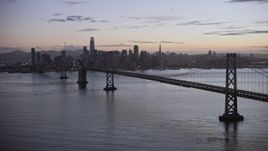 6K aerial stock footage of the Downtown San Francisco skyline and Bay Bridge at twilight, California Aerial Stock Footage | AX0174_0114