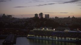6K aerial stock footage of Coit Tower seen from a docked cruise ship at twilight, San Francisco, California Aerial Stock Footage | AX0174_0120
