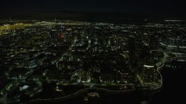 6K aerial stock footage of approaching Downtown Oakland office buildings from Lake Merritt at night, California Aerial Stock Footage | AX0174_0127