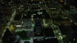 6K aerial stock footage of approaching and flying by Oakland City Hall in Downtown Oakland at night, California Aerial Stock Footage | AX0174_0128