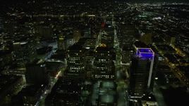 6K aerial stock footage of flying by Oakland City Hall and government office building in Downtown Oakland at night, California Aerial Stock Footage | AX0174_0129
