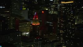 6K aerial stock footage of Tribune Tower in Downtown Oakland at night, California Aerial Stock Footage | AX0174_0131