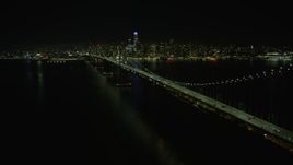 6K aerial stock footage follow the Bay Bridge toward Downtown San Francisco at night, California Aerial Stock Footage | AX0174_0137