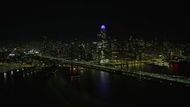 6K aerial stock footage of flying by the Bay Bridge and Downtown San Francisco skyline at night, California Aerial Stock Footage | AX0174_0139