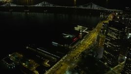 6K aerial stock footage flyby skyscraper to reveal Ferry Building at night, Downtown San Francisco, California Aerial Stock Footage | AX0174_0145