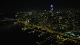6K aerial stock footage fly away from Ferry Building at night, reveal Downtown San Francisco skyscrapers, California Aerial Stock Footage | AX0174_0146