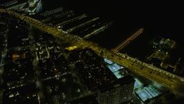6K aerial stock footage fly over Downtown San Francisco, tilt to skyscrapers and piers at night, California Aerial Stock Footage | AX0174_0158