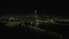 6K aerial stock footage fly over Bay Bridge toward Downtown San Francisco skyline at night, California Aerial Stock Footage | AX0174_0162
