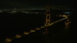 6K aerial stock footage flyby the Golden Gate Bridge at night with San Francisco in the background, California Aerial Stock Footage | AX0174_0180