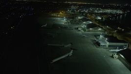 6K aerial stock footage passing commercial airplanes while landing at Oakland Airport at night, California Aerial Stock Footage | AX0174_0202