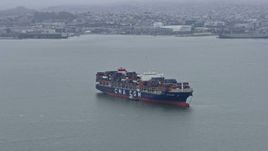 6K aerial stock footage flying by a cargo ship sailing San Francisco Bay, California Aerial Stock Footage | AX0175_0001