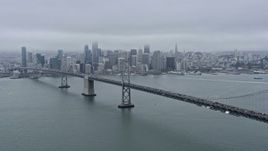 6K aerial stock footage flying past the Bay Bridge with a wide view of Downtown San Francisco, California Aerial Stock Footage | AX0175_0002