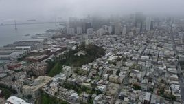 6K aerial stock footage of Coit Tower and Downtown San Francisco on a foggy day, California Aerial Stock Footage | AX0175_0008