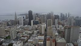 6K aerial stock footage of flying by downtown skyscrapers in San Francisco on a foggy day, California Aerial Stock Footage | AX0175_0015
