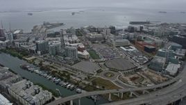 6K aerial stock footage of office buildings near the arena in San Francisco on a foggy day, California Aerial Stock Footage | AX0175_0017
