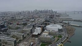 6K aerial stock footage of downtown skyscrapers seen from Chase Center in San Francisco on a foggy day, California Aerial Stock Footage | AX0175_0018