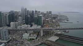 6K aerial stock footage fly over the Bay Bridge and past Downtown San Francisco on a foggy day, California Aerial Stock Footage | AX0175_0021