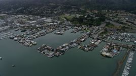 6K aerial stock footage of houseboats docked at a harbor in Sausalito on a foggy day, California Aerial Stock Footage | AX0175_0038