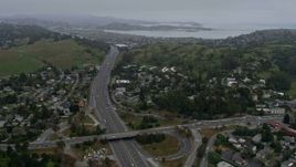6K aerial stock footage fly over Highway 101 and suburban homes in Mill Valley on a foggy day, California Aerial Stock Footage | AX0175_0040