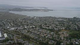 6K aerial stock footage fly over Corte Madera neighborhoods, San Quentin in the distance, on a foggy day, California Aerial Stock Footage | AX0175_0041