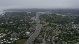 6K aerial stock footage following Highway 101 through Mill Valley on a foggy day, California Aerial Stock Footage | AX0175_0059
