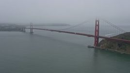 6K aerial stock footage of passing by the Golden Gate Bridge on a foggy day, San Francisco, California Aerial Stock Footage | AX0175_0067