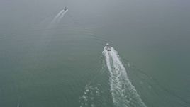 6K aerial stock footage of ferries sailing San Francisco Bay on a foggy day, San Francisco, California Aerial Stock Footage | AX0175_0068
