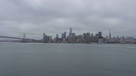 6K aerial stock footage of the Downtown San Francisco skyline on a foggy day, seen from the bay, California Aerial Stock Footage | AX0175_0074