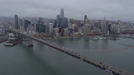 6K aerial stock footage of Downtown San Francisco on a foggy day, seen from the Bay Bridge, California Aerial Stock Footage | AX0175_0076