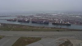 6K aerial stock footage of cargo ships docked at the Port of Oakland, California Aerial Stock Footage | AX0175_0080