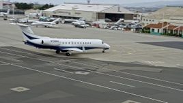6K aerial stock footage of a private jet at Oakland Airport, California Aerial Stock Footage | AX0175_0094