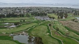 6K aerial stock footage fly over golf course, tilt to parking lot in Alameda, California Aerial Stock Footage | AX0175_0095