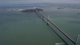 6K aerial stock footage tilt from the Bay Bridge to reveal Yerba Buena Island, San Francisco, California Aerial Stock Footage | AX0175_0132