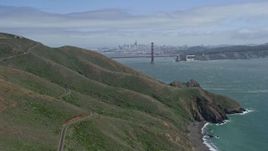 6K aerial stock footage wide view of the Golden Gate Bridge seen while passing the Marin hills, San Francisco, California Aerial Stock Footage | AX0175_0167