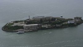 6K aerial stock footage orbit Alcatraz as a ferry sails by, San Francisco Bay, California Aerial Stock Footage | AX0175_0204