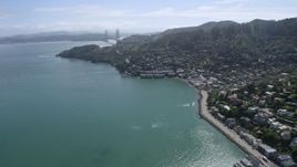 6K aerial stock footage of flying by Sausalito neighborhoods with the Golden Gate Bridge in the distance, California Aerial Stock Footage | AX0175_0209